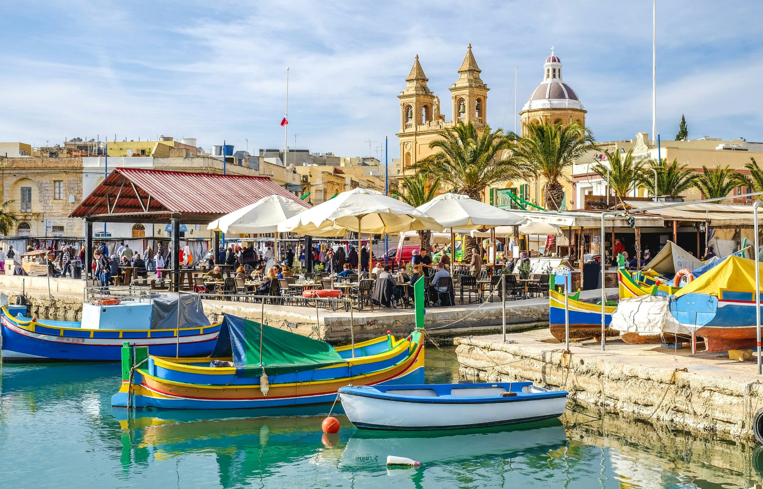 Colourful boats docked in the harbour in Malta