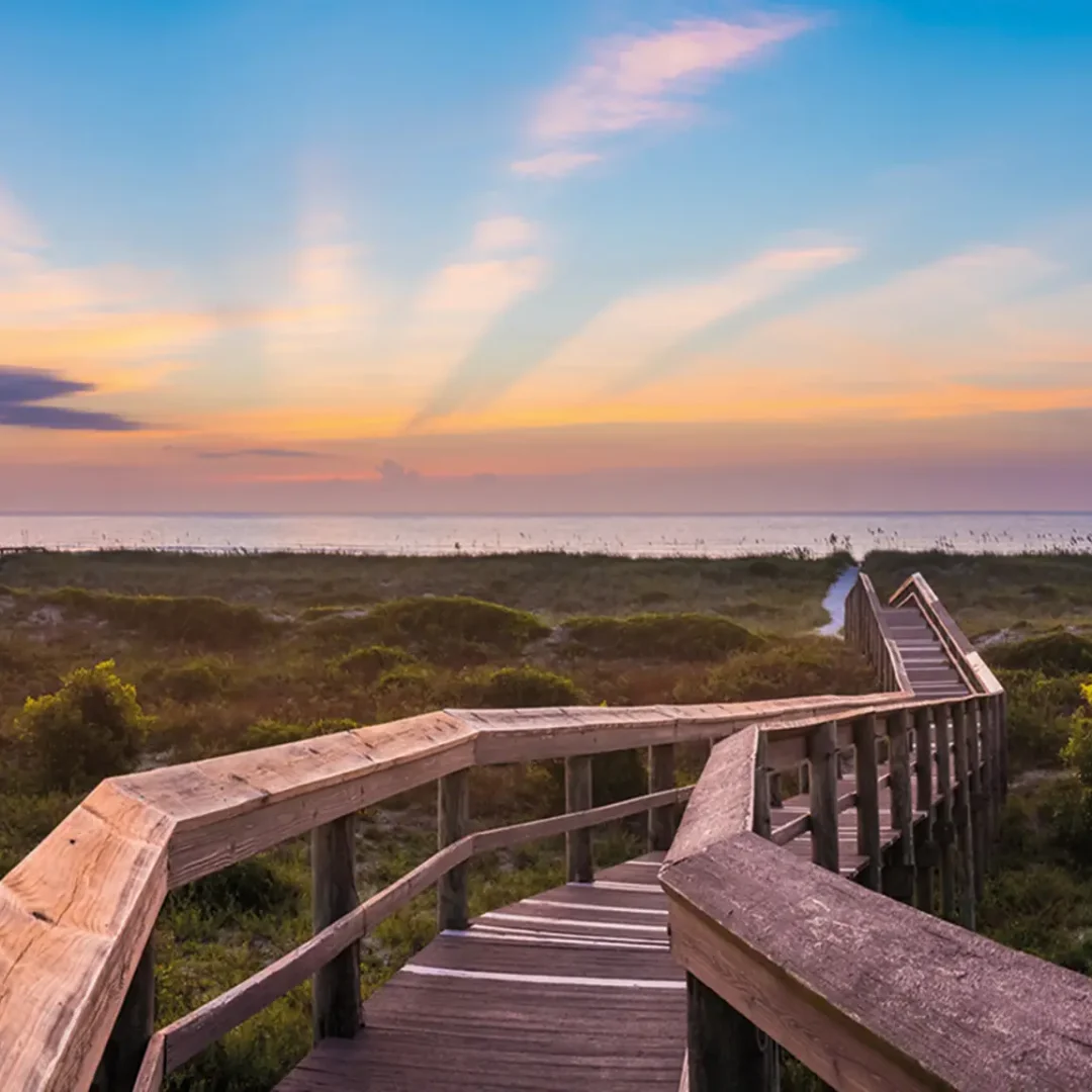 A bridge stretches across a field into the sunset on Amelia Island