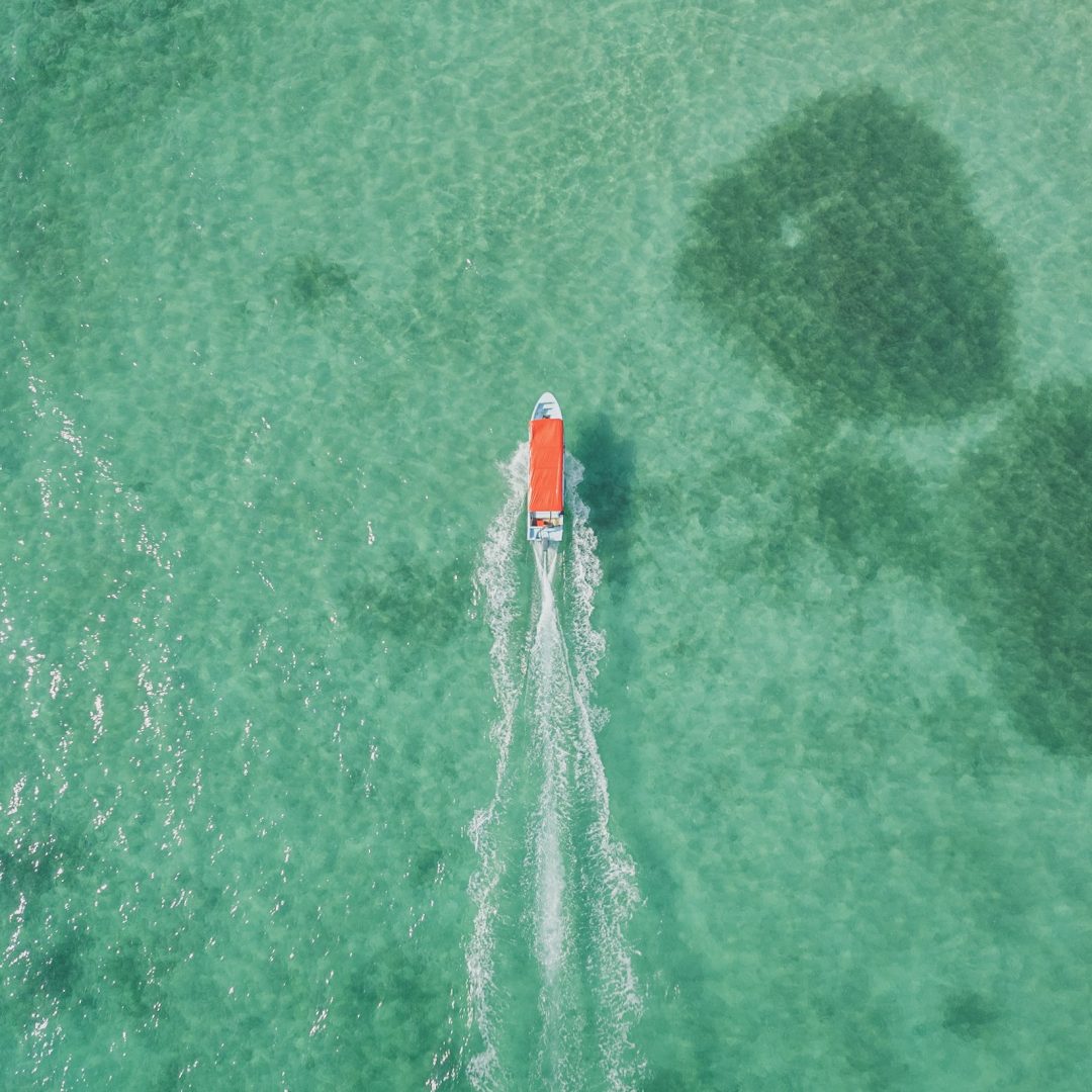 A boat on turquoise Caribbean ocean. Credit: Connor McCracken