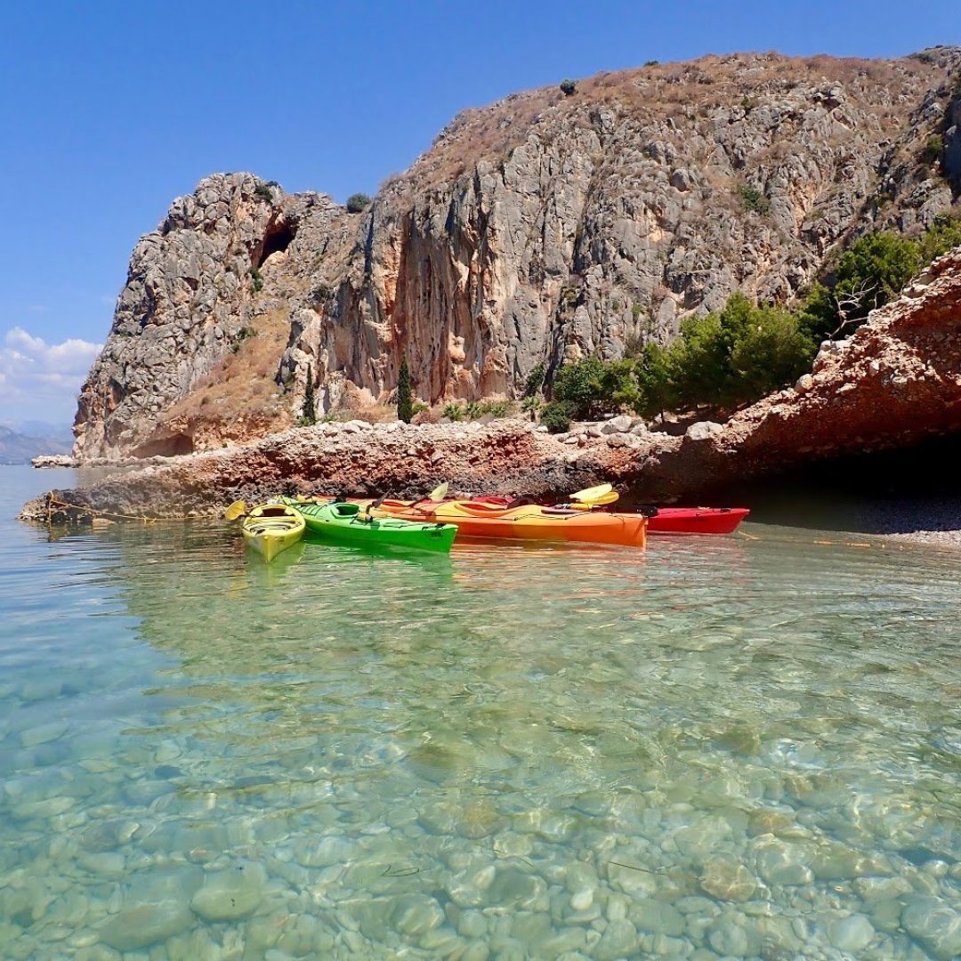 Colourful kayaks bob in the ocean in Nafplio, Greece