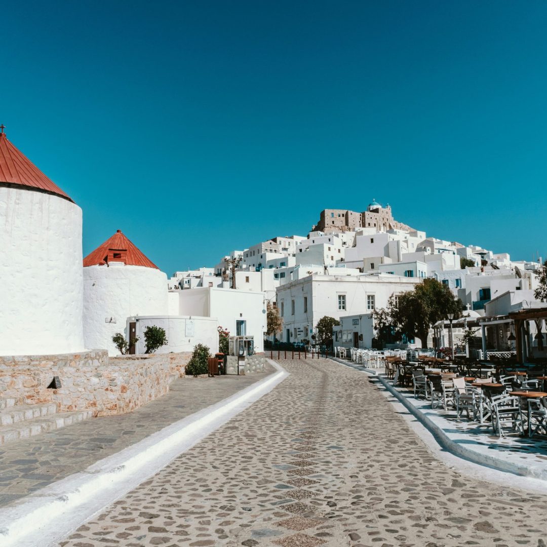 A cobbled street with white buildings in Astypalaia, Greece