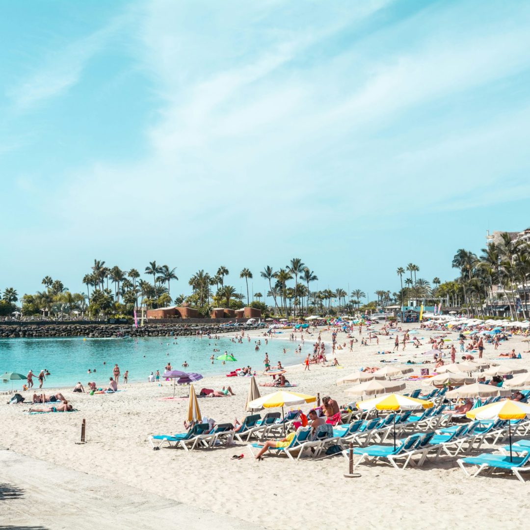 Crowds flock to sunbathe on a beach in the Canary Islands