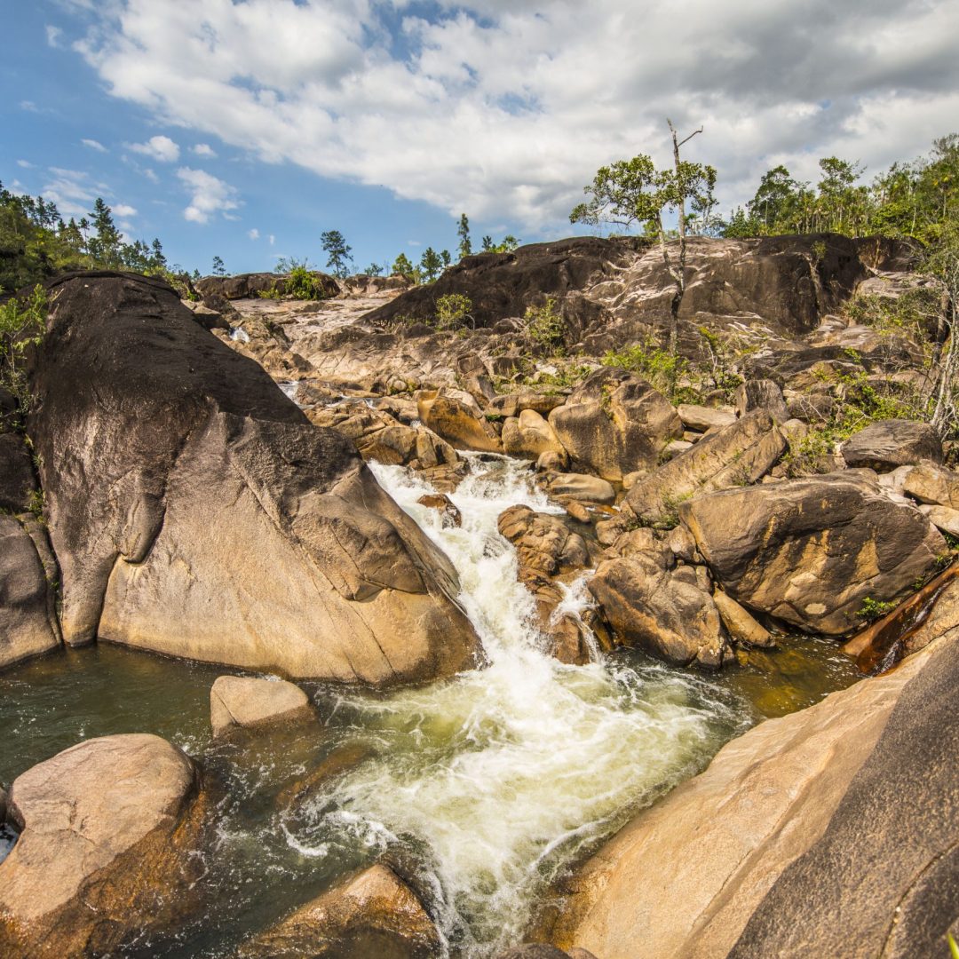 the Rio On Pools, a series of natural swimming holes and small waterfalls located within the Mountain Pine Ridge Forest Reserve in Belize